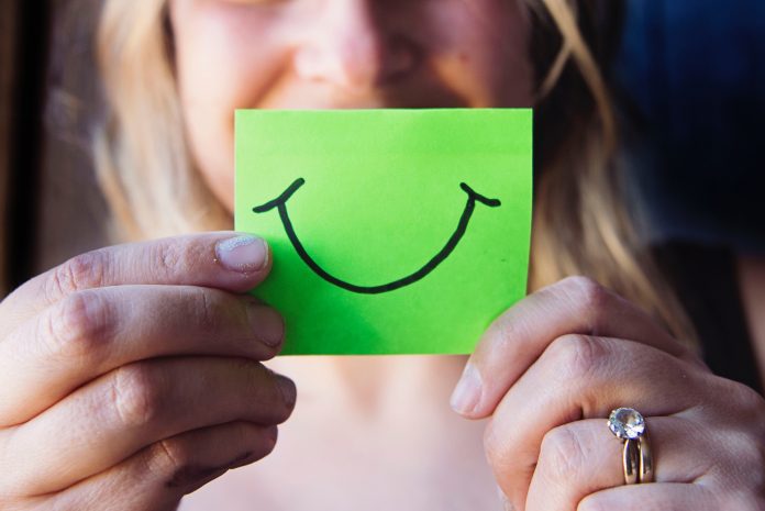 photo-of-woman-holding-a-green-paper-736842